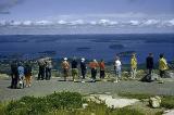 Visitors stand on Cadillac Mountain to survey tiny islands below.