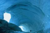 An enormous icy tunnel that looks like the inside of a cave in Antarctica.